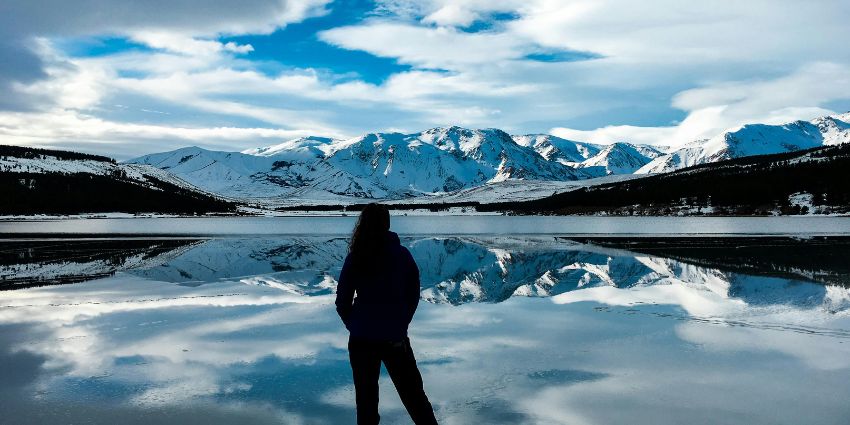 A breathtaking view of Argentina’s snowy peaks mirrored in a tranquil lake.