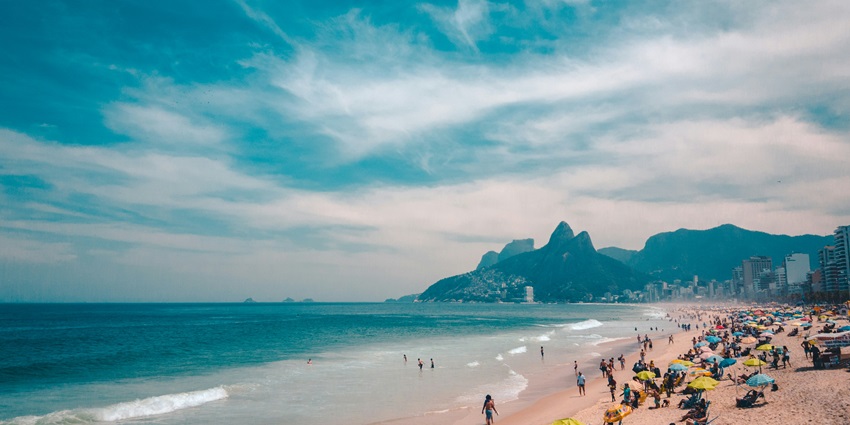 A stunning beach in Brazil with golden sands, blue waters, and vibrant city views.