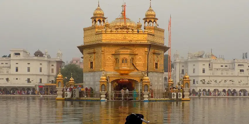 The Golden Temple in India, a sacred Sikh shrine, reflecting in the holy water.