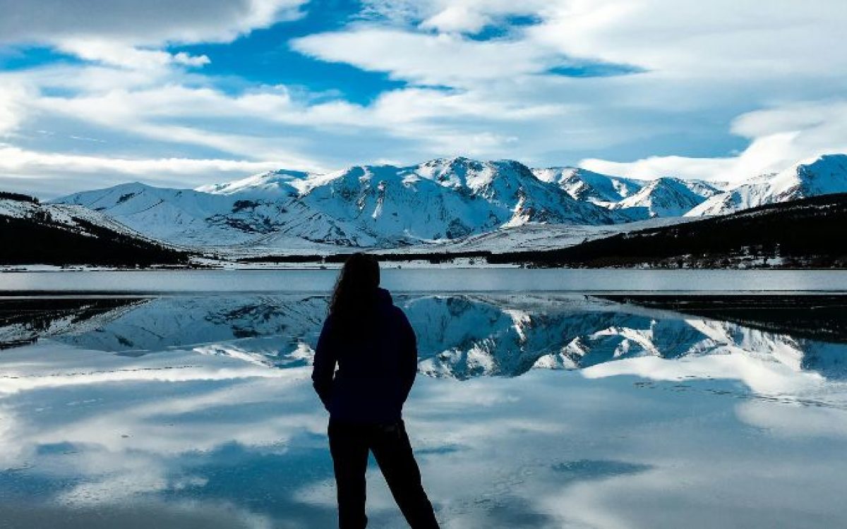 A breathtaking view of Argentina’s snowy peaks mirrored in a tranquil lake.